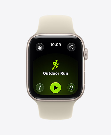 Apple Watch SE 3, aluminum case, starlight color, screen shows Workout app (outdoor run), right side exterior, Digital Crown dial, Sport Band, sand color (pale tan)