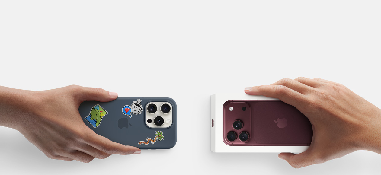 Due mani che si scambiano un iPhone 16 Pro usato color argento con custodia in silicone coperta di adesivi sul retro e un iPhone 18 Pro nuovo borgogna (rosso scuro) ancora nella confezione.